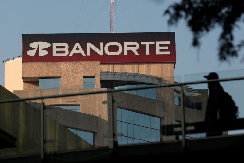 © Reuters. FILE PHOTO: Man walks past the headquarters of Banorte bank in Monterrey