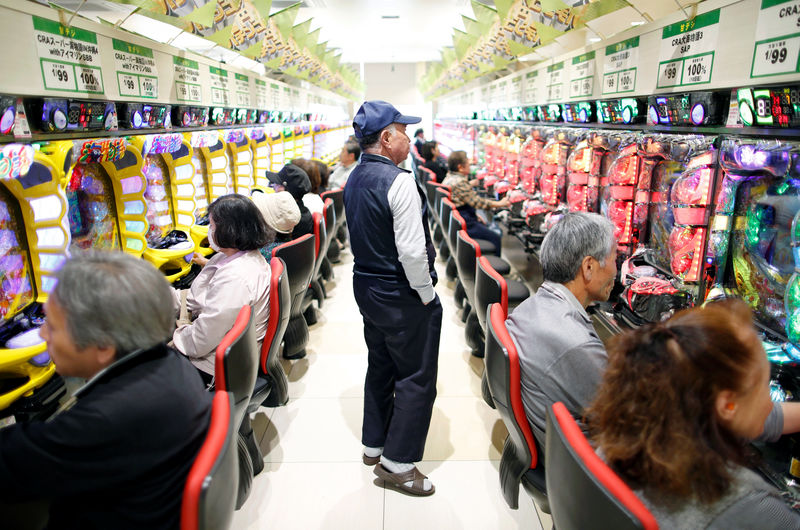 © Reuters. Visitors play pachinko, a Japanese form of legal gambling, at a pachinko parlour in Fukushima