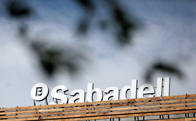 © Reuters. FILE PHOTO - The Banco Sabadell logo can be seen behind leaves on top of a building outside Madrid, Spain