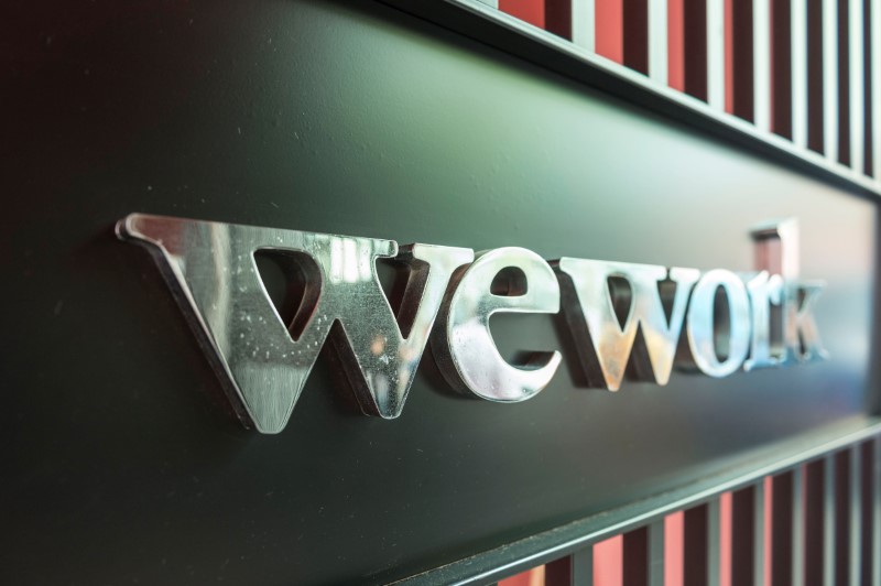 © Reuters. FILE PHOTO: Logo of U.S. co-working firm WeWork is pictured during a signing ceremony in Shanghai