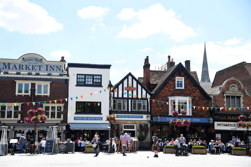 © Reuters. FILE PHOTO: People walk along the high street in Salisbury