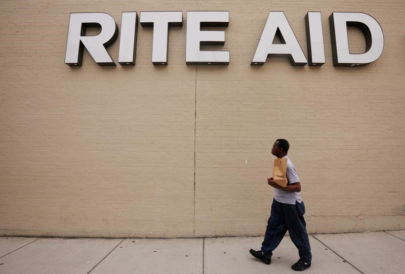 © Reuters. Pedestrian passes a sign for a Rite Aid pharmacy in Somerville