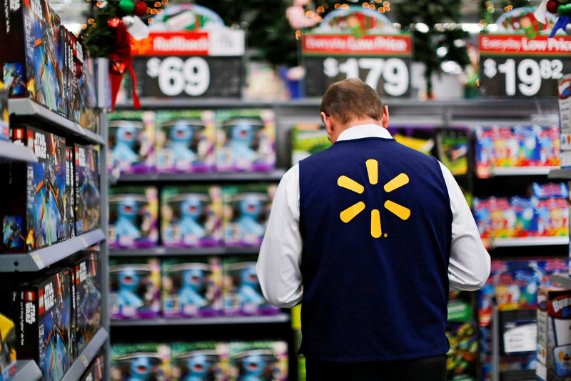 © Reuters. FILE PHOTO: A Walmart worker organises products for Christmas season at a Walmart store in Teterboro