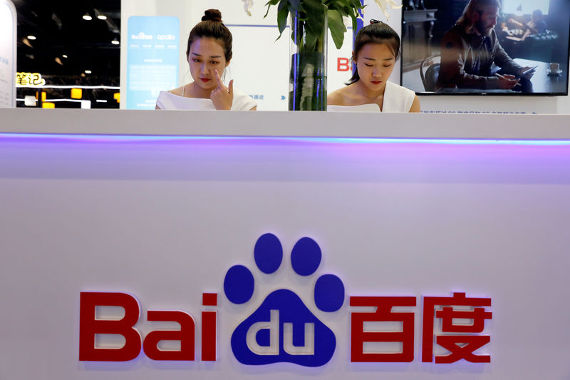 © Reuters. FILE PHOTO: Members of staff work at the Baidu booth during Global Mobile Internet Conference (GMIC) at the National Convention in Beijing