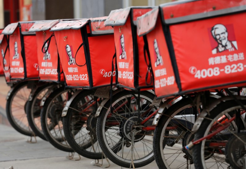 © Reuters. Logos of KFC, owned by Yum Brands Inc, are seen on its delivery bicycles in front of its restaurant in Beijing