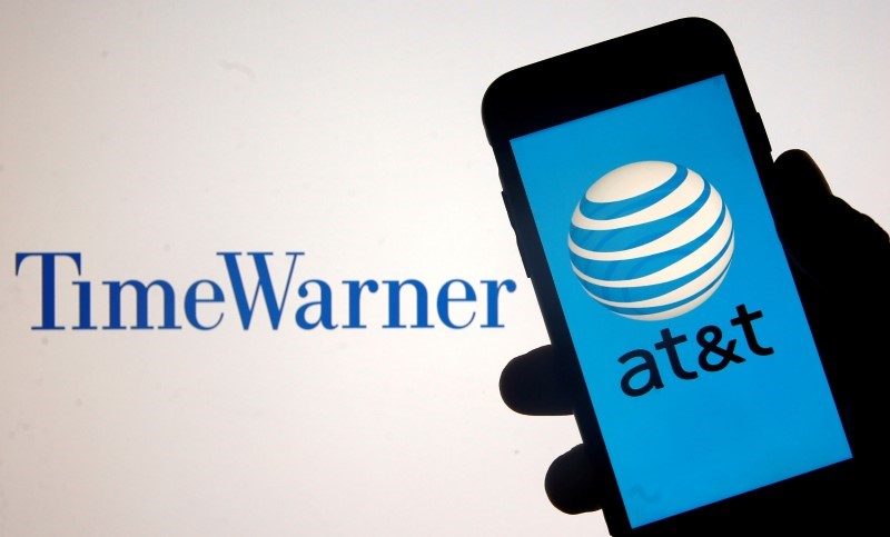 © Reuters. FILE PHOTO:    Smartphone with AT&T logo is seen in front of displayed Time Warner logo in this picture illustration