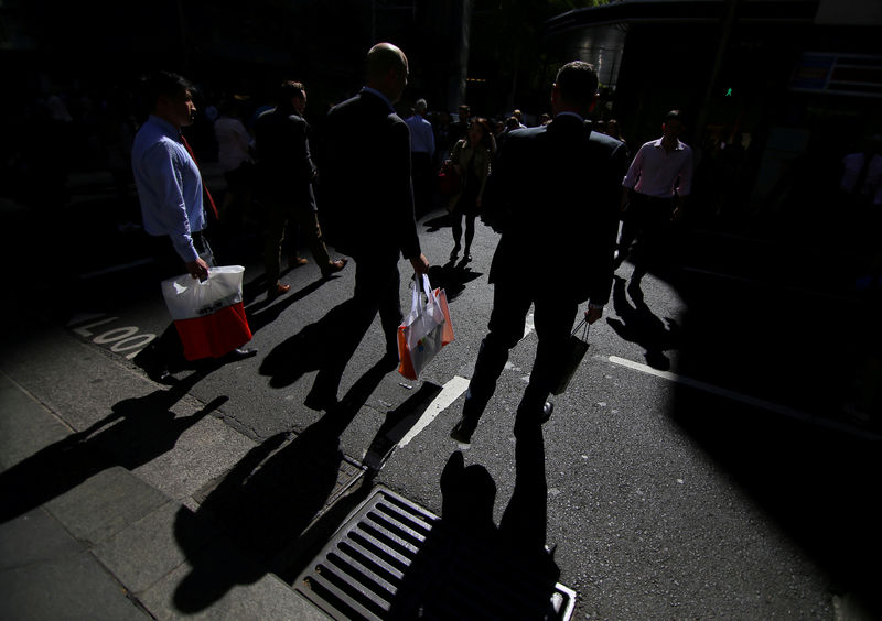© Reuters. FILE PHOTO: Workers walk on the streets of Sydney, Australia