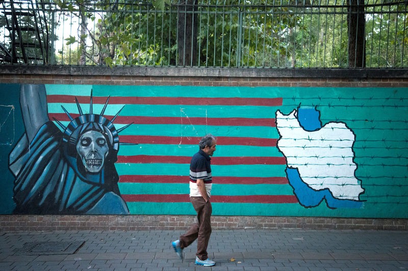 © Reuters. FILE PHOTO: Man walks past anti-U.S. mural in Tehran