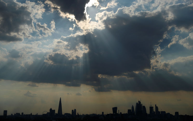 © Reuters. Sunlight breaks through the clouds above the financial district of London