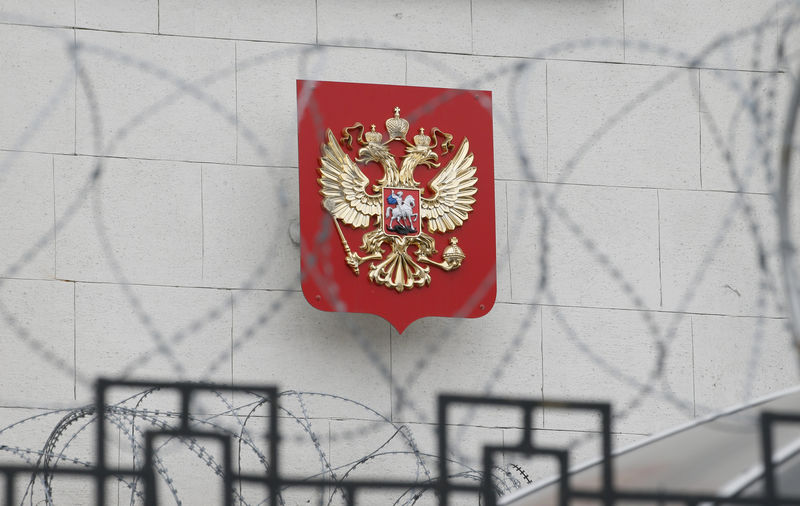 © Reuters. FILE PHOTO: A coat of arms is seen through barbed wire on the wall of the Russian embassy in Kiev