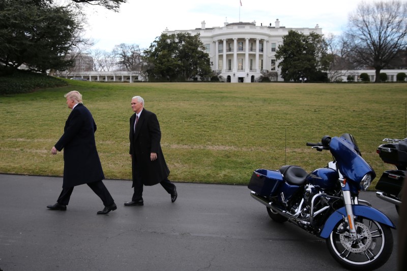 © Reuters. U.S. President Trump and Vice President Pence leaves after meeting with Harley Davidson executives at the South Lawn of the White House