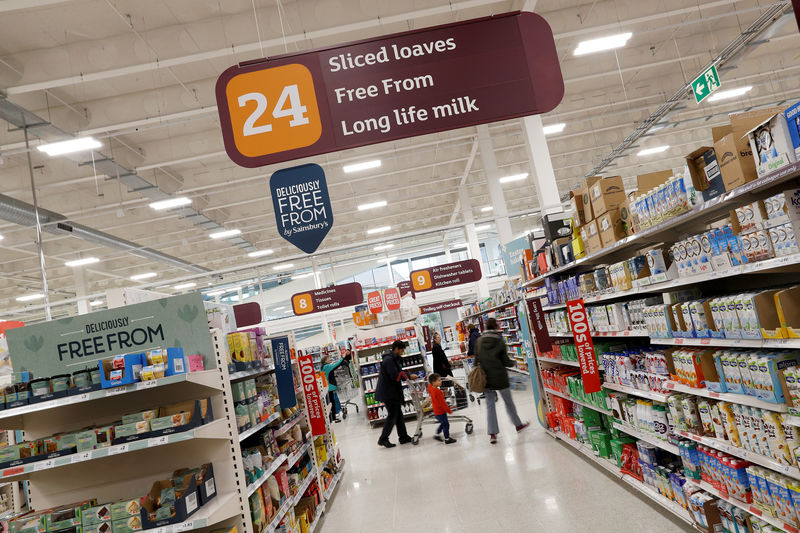 © Reuters. FILE PHOTO: Customers shop in a Sainsbury's store in Redhill