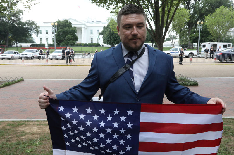 © Reuters. El líder nacionalista blanco Jason Kessler sostiene una bandera frente a la Casa Blanca durante un mitin que marca el primer aniversario de las protestas de Charlottesville "Unite the Right" en Washington, D.C.