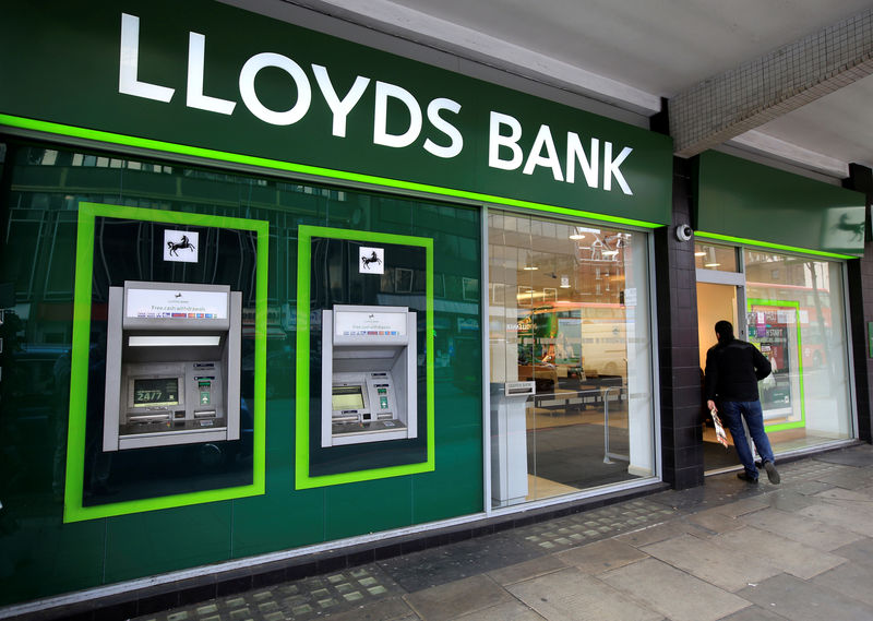 © Reuters. FILE PHOTO: A man enters a Lloyds Bank branch in central London