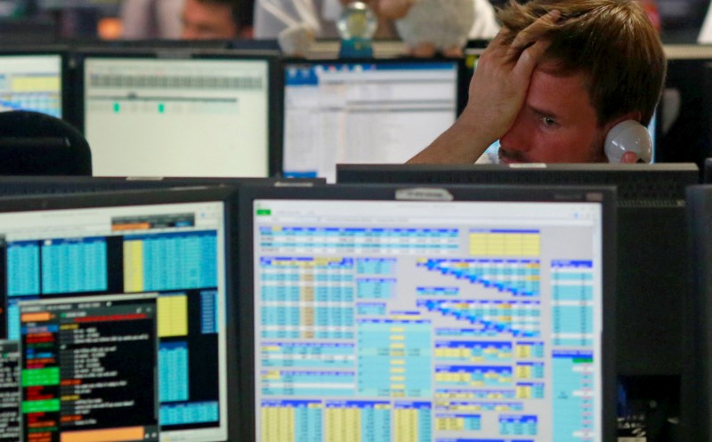 © Reuters. Traders from BGC, a global brokerage company in London's Canary Wharf financial centre react as European stock markets open