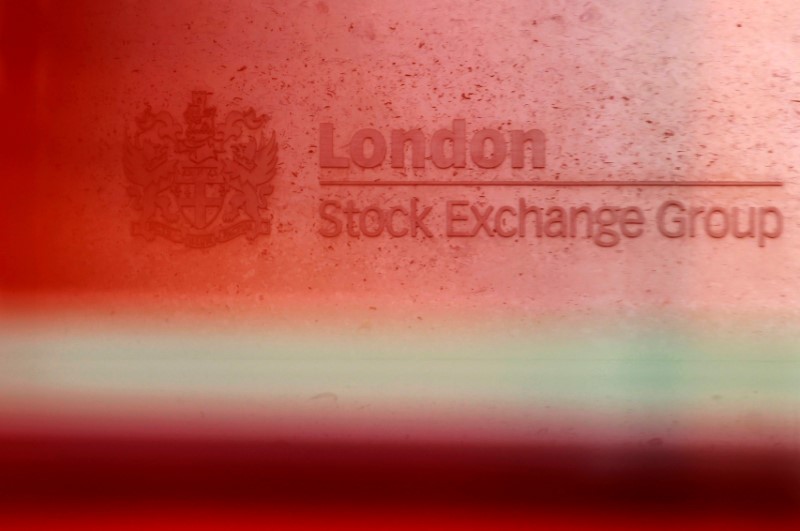 © Reuters. A red London bus passes the Stock Exchange in London