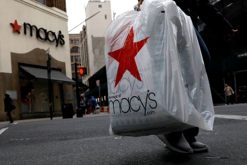 © Reuters. FILE PHOTO: A customer exits after shopping at a Macy's store in the Brooklyn borough of New York