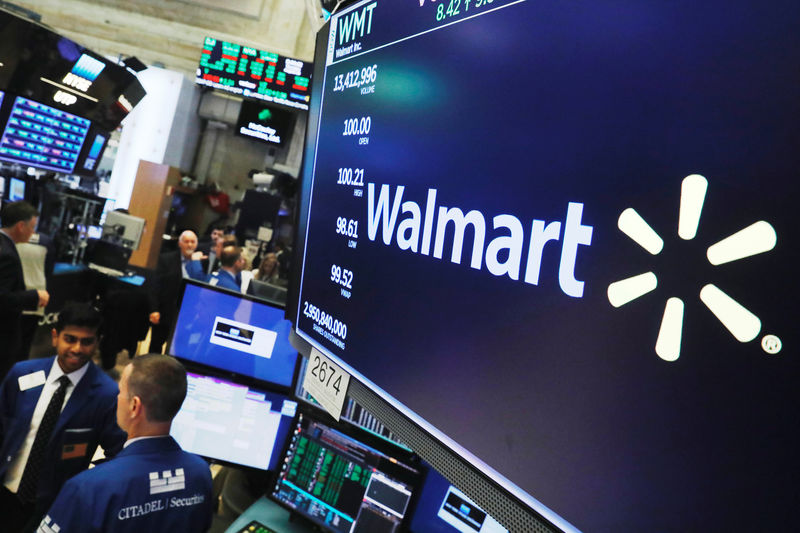 © Reuters. A Walmart logo is displayed above the floor of the New York Stock Exchange shortly after the opening bell in New York