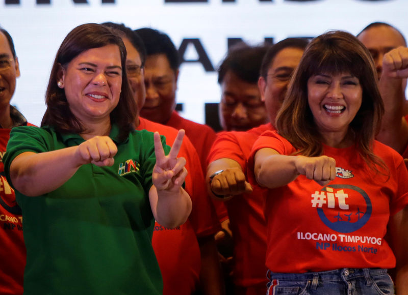 © Reuters. Davao City Mayor Sara Duterte-Carpio (L)  and Ilocos Norte Governor Imee Marcos gestures during an alliance meeting with local political parties in Paranaque, Metro Manila
