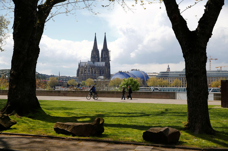 © Reuters. People stroll through a park near the Cologne Cathedral in Cologne