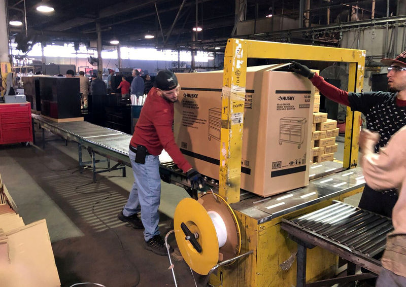 © Reuters. FILE PHOTO: Employees seen working inside the Metal Box International toolbox factory in Franklin Park