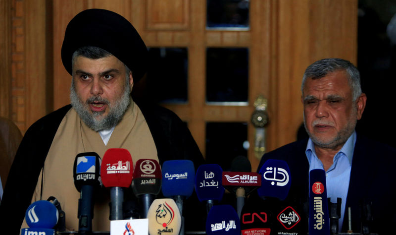 © Reuters. FILE PHOTO: Iraqi Shi'ite cleric Moqtada al-Sadr speaks during a news conference with Leader of the Conquest Coalition and the Iran-backed Shi'ite militia Badr Organisation Hadi al-Amiri, in Najaf