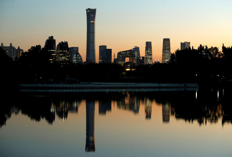 © Reuters. FILE PHOTO: Cityscape of the Beijing Central Business District is reflected in a pond during sunset