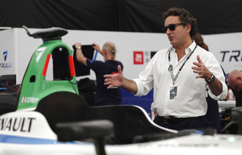 © Reuters. Agag, Formula E CEO, gestures next to Michela Cerruti's Formula E car in the box during an interview with Reuters in Buenos Aires