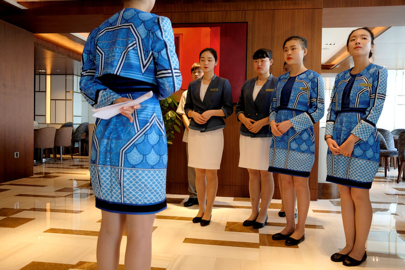 © Reuters. FILE PHOTO: Attendants are trained at the executive lounge of Atlantis Sanya hotel in Sanya