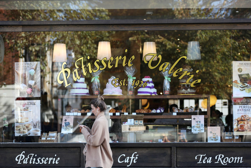 © Reuters. FILE PHOTO: A woman walks past a branch of Patisserie Valerie in London