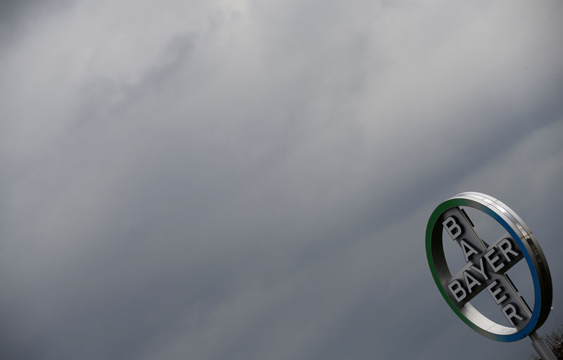 © Reuters. FILE PHOTO: A logo of Bayer is seen next to dark clouds at Cologne Bonn airport