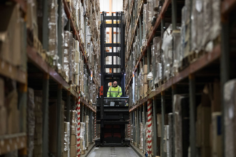 © Reuters. An employee operates a forklift to move goods at the Miniclipper Logistics warehouse in Leighton Buzzard