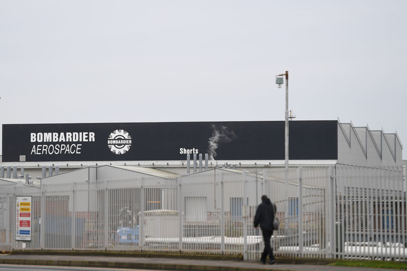 © Reuters. FILE PHOTO: A man walks past the Bombardier plant in Belfast