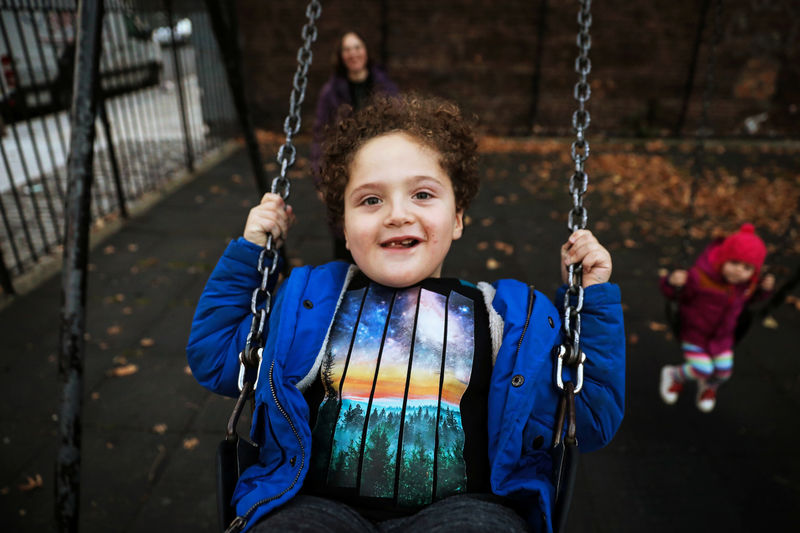 © Reuters. Natan is pushed on a swing by his mother, Reuters' U.S. Health Editor Michele Gershberg, in a park in New York
