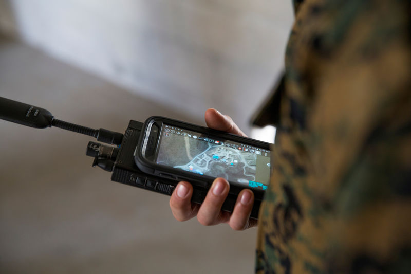 © Reuters. FILE PHOTO: A U.S. Marine is assessed utilizing a communications radio with real time on screen GPS location at Camp Pendleton