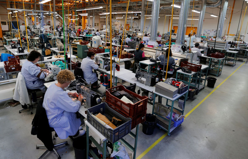 © Reuters. Employees work with pieces of leather at a workshop at the shoemaker J.M. Weston factory in Limoges