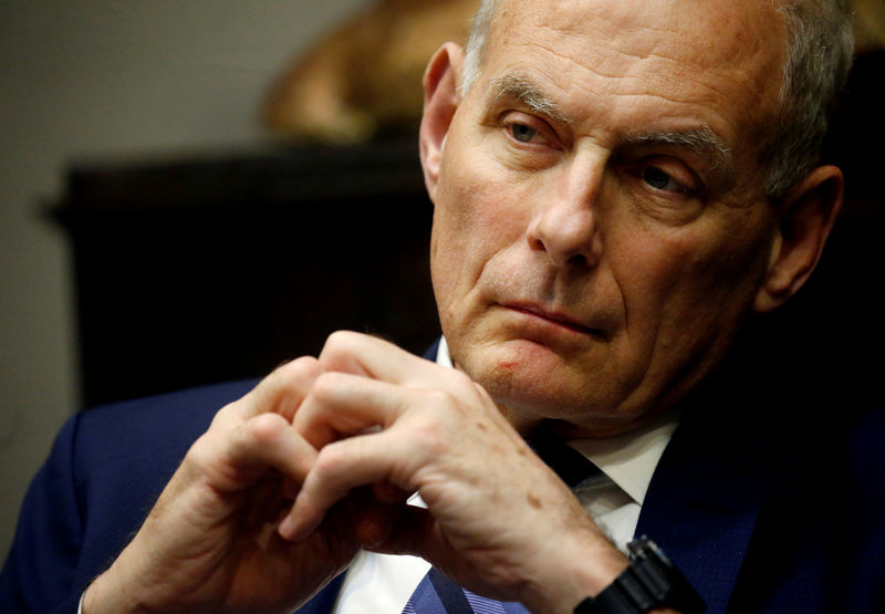 © Reuters. FILE PHOTO: White House Chief of Staff Kelly listens as U.S. President Trump takes part in a working lunch at the White House in Washington