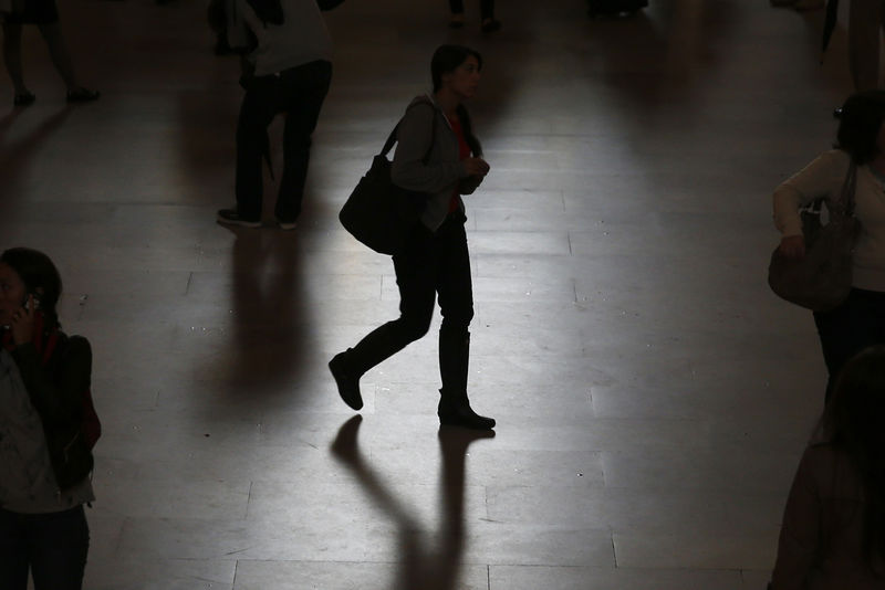 © Reuters. A woman is seen in silhouette walking through Grand Central Station in New York