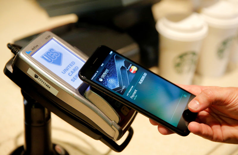 © Reuters. FILE PHOTO: Man uses iPhone 7 smartphone to demonstrate mobile payment service Apple Pay at cafe in Moscow
