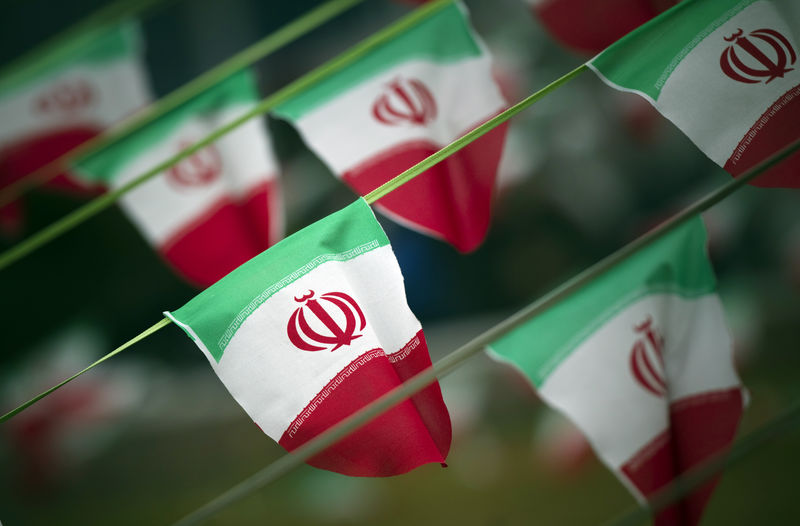 © Reuters. Iran's national flags are seen on a square in Tehran