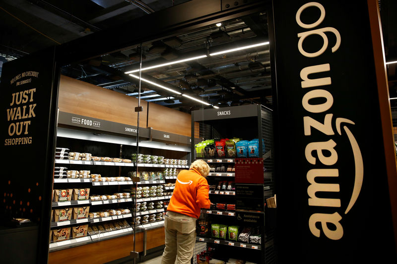© Reuters. Amazon associate Umipig checks inventory at a smaller format Amazon Go store in the Blue Shift office in Seattle