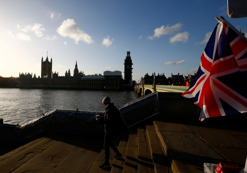 © Reuters. A person walks down the stairs of Westminster Bridge opposite the Houses of Parliament in London