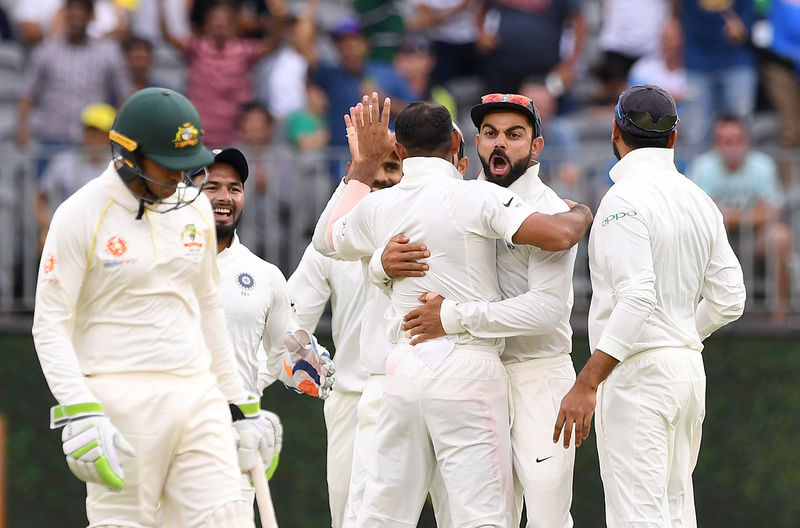 © Reuters. India's captain Kohli celebrates with his teammates at Perth Stadium in Perth