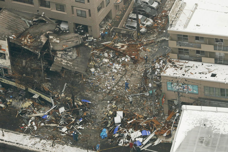 © Reuters. An aerial view shows workers inspecting the site where a large explosion occurred at a restaurant in Sapporo