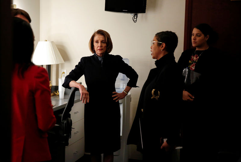 © Reuters. FILE PHOTO: House Minority Leader Nancy Pelosi (D-CA) speaks with members of her staff before speaking to the media on Capitol Hill in Washington