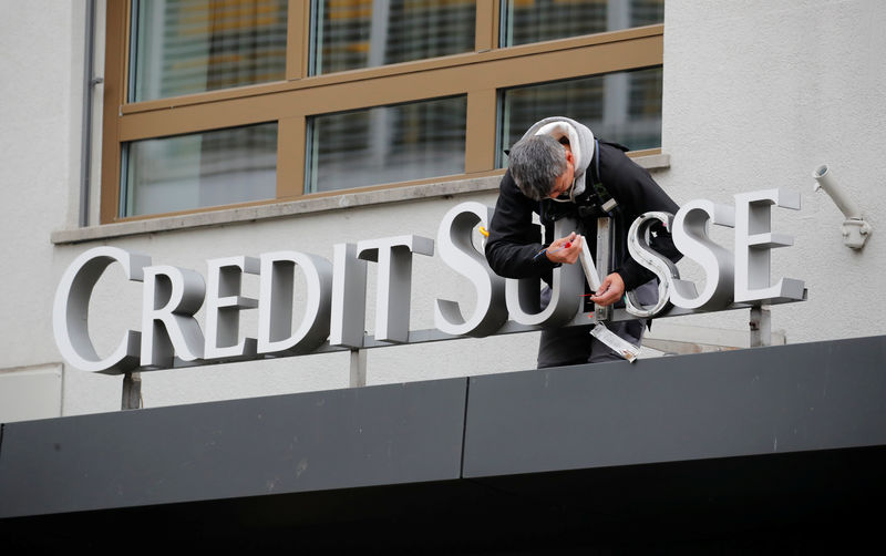 © Reuters. A worker repairs the logo of Swiss bank Credit Suisse in Zurich