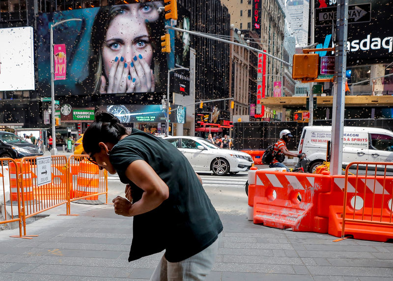 © Reuters. Mulher reage a surto de abelhas na Times Square, Nova York