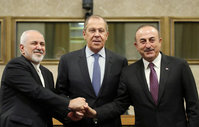 © Reuters. Russian Foreign Minister Lavrov, Turkish Foreign Minister Cavusoglu and Iranian Foreign Minister Zarif, attend the joint news conference after talks on forming a constitutional committee in Syria, at the United Nations in Geneva