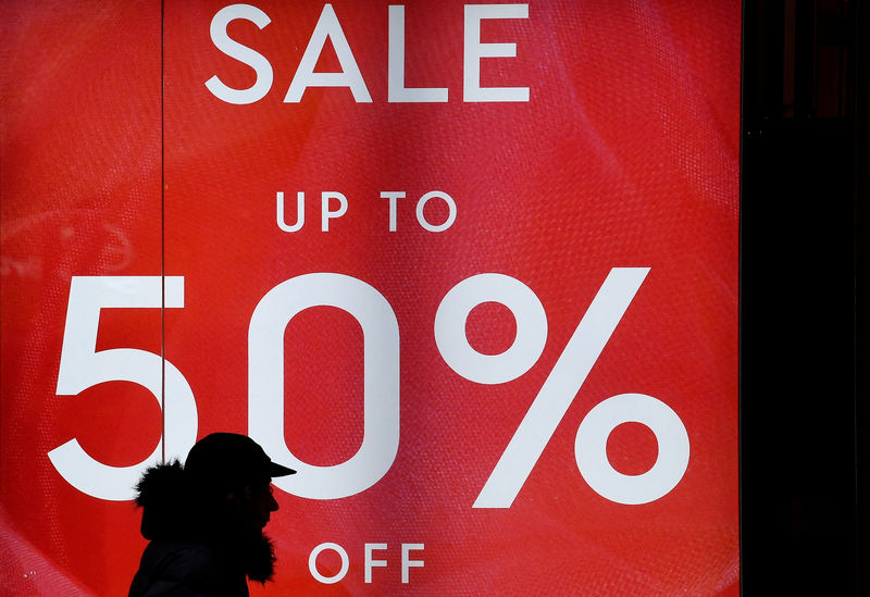 © Reuters. FILE PHOTO: A person walks past a sale sign on Oxford Street in London