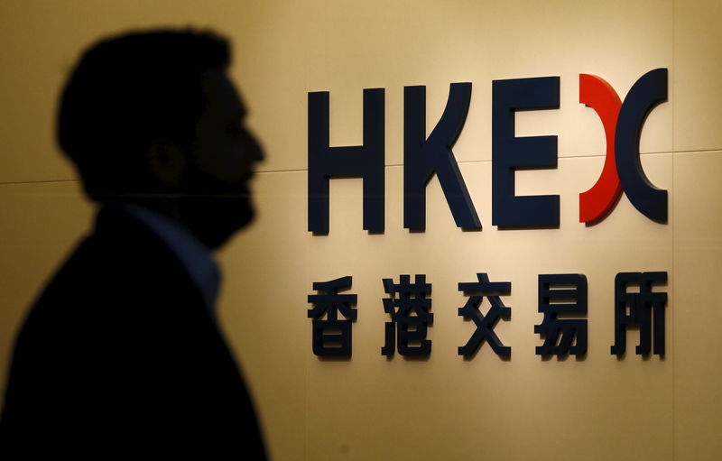 © Reuters. A man walks past the entrance to the Hong Kong Exchanges bearing a new logo in Hong Kong